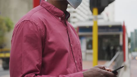 African-american-man-on-the-go-wearing-coronavirus-covid19-mask