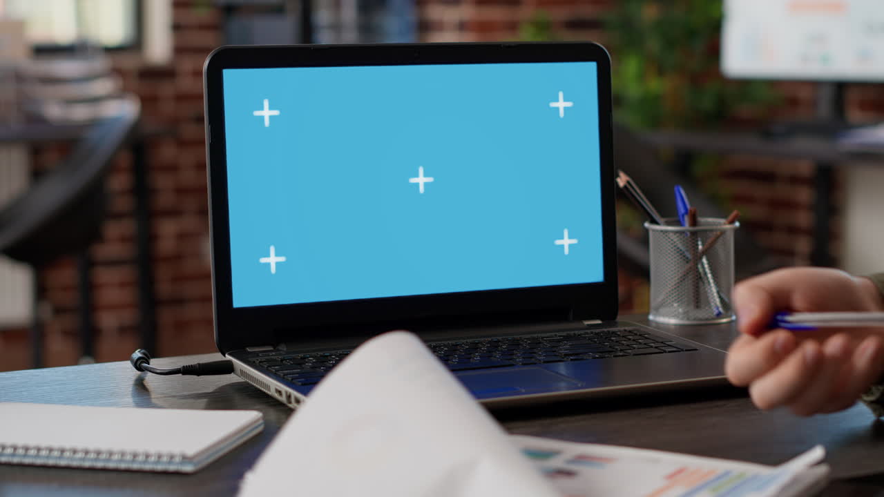 Male freelancer analyzing business charts and greenscreen