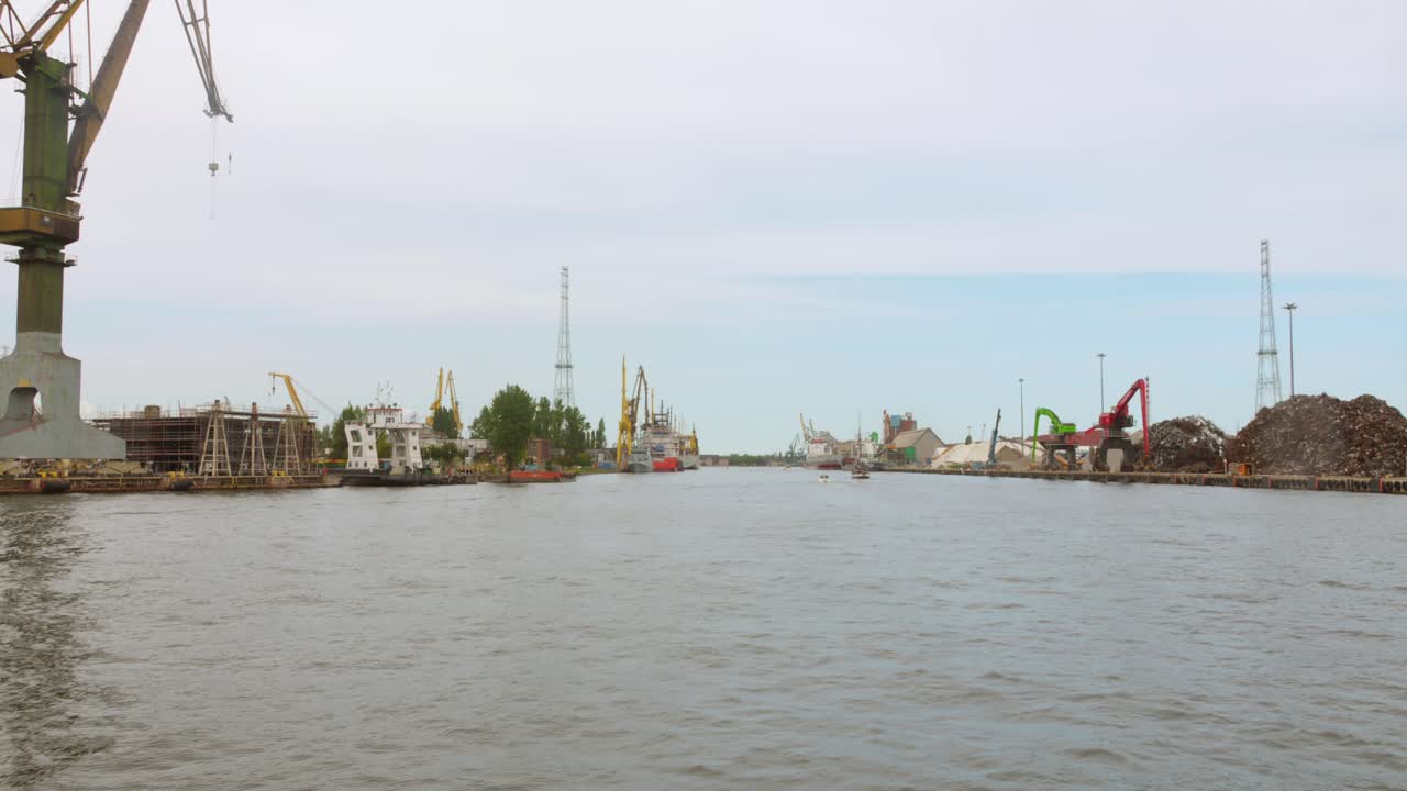 Discover the vibrant industrial activities at the Gdansk seaport, showcasing cranes, vessels, and the bustling maritime economy along the Baltic coast.