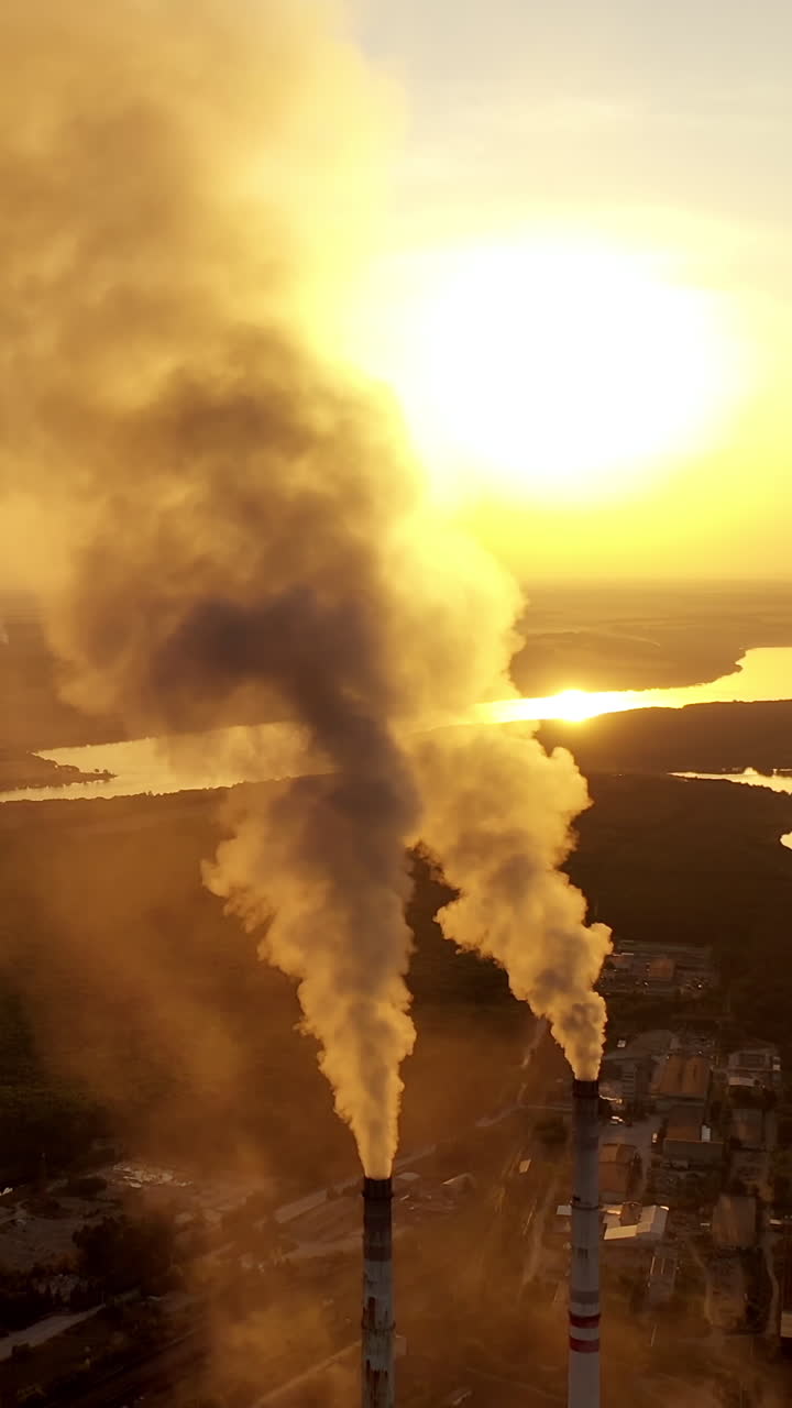 Smoking pipes of factory. Smoking factory chimney and plant pipe. Vertical video