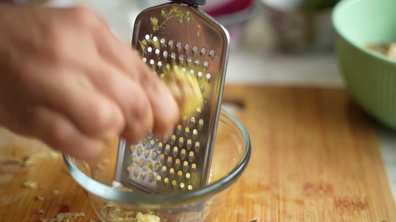 Grating of garlic by a traditional grater.