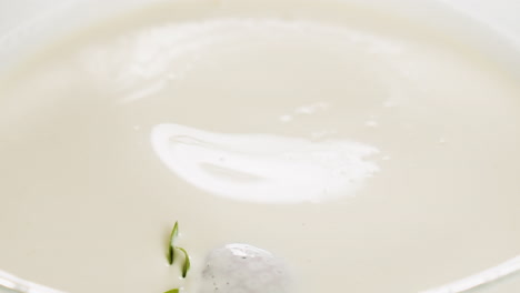 Close-up-slow-motion-video-of-strawberry-falling-into-milk-and-splashing