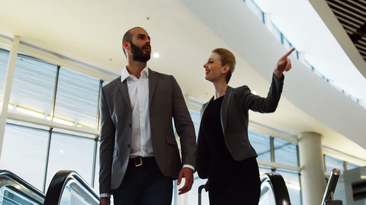 Business people interacting on an escalator