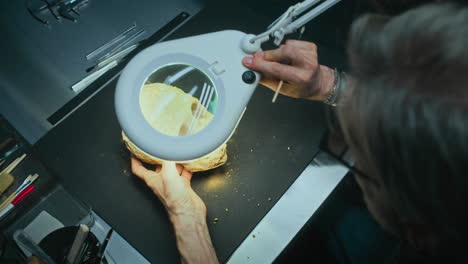 archaeologist cleaning a fossil skull