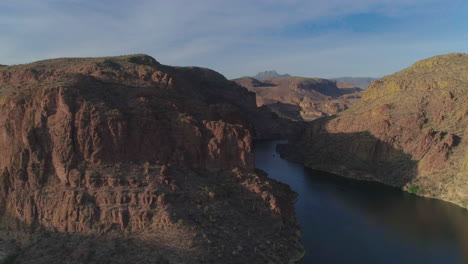 aerial - drone pan of narrow waterway in between mountains