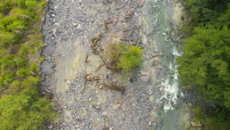 aerial top down view of stream through mountains near locarno and spruga, switzerland