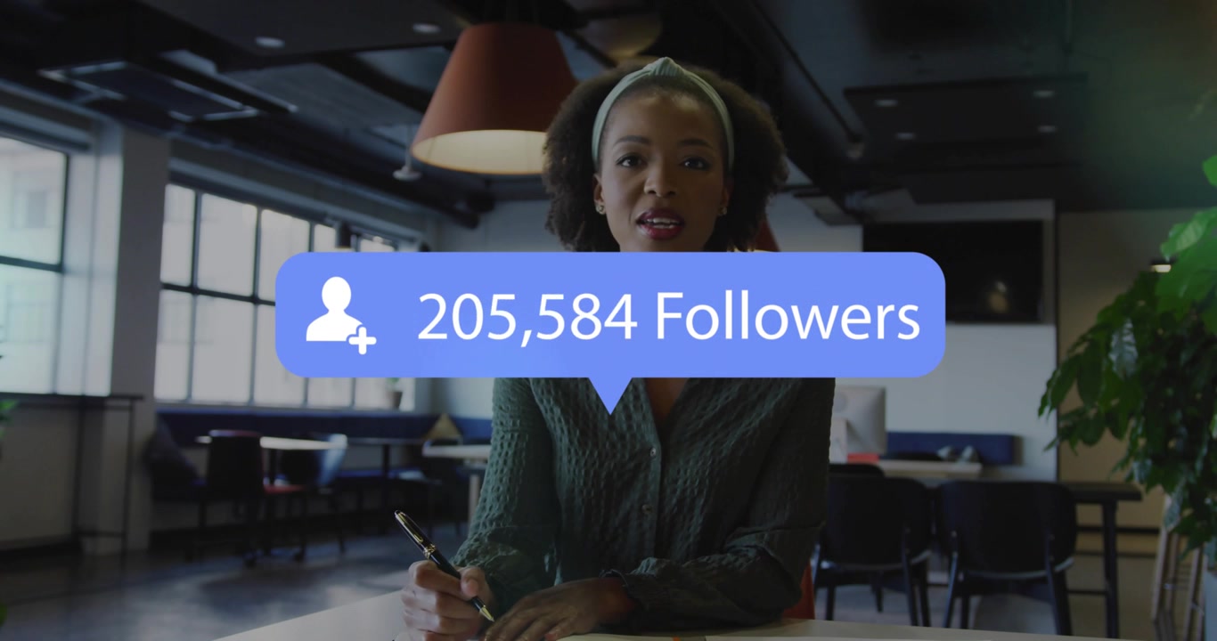 Woman writing notes causing blue follower overlays animating growing counts for social media growth