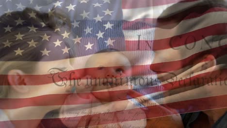 caucasian family with us flag waving and independence declaration foreground