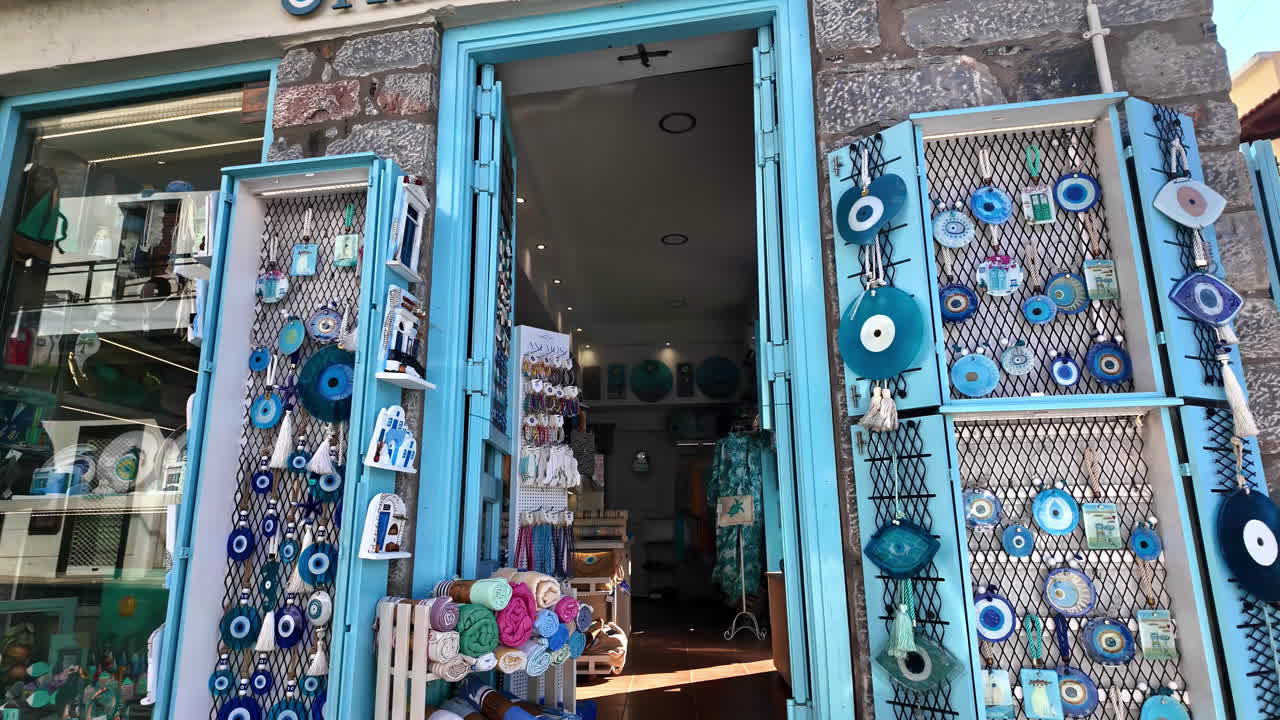 Motion video capturing various garments, souvenir shops at Schisma Eloundas city in Greece. Day view.