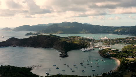 aerial shot of sunset in english harbor in antigua, caribbean with views of yachts, sailboats, marina, bay and cliffs