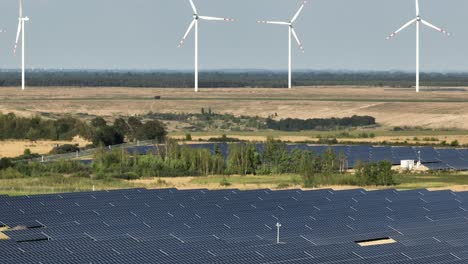 solar panel photovoltaic base farm station and windmill for energy clean green renewable production aerial footage agenda 2030 concept