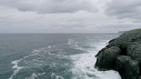 Aerial-tracking-over-a-rocky-coastline-out-in-the-north-sea