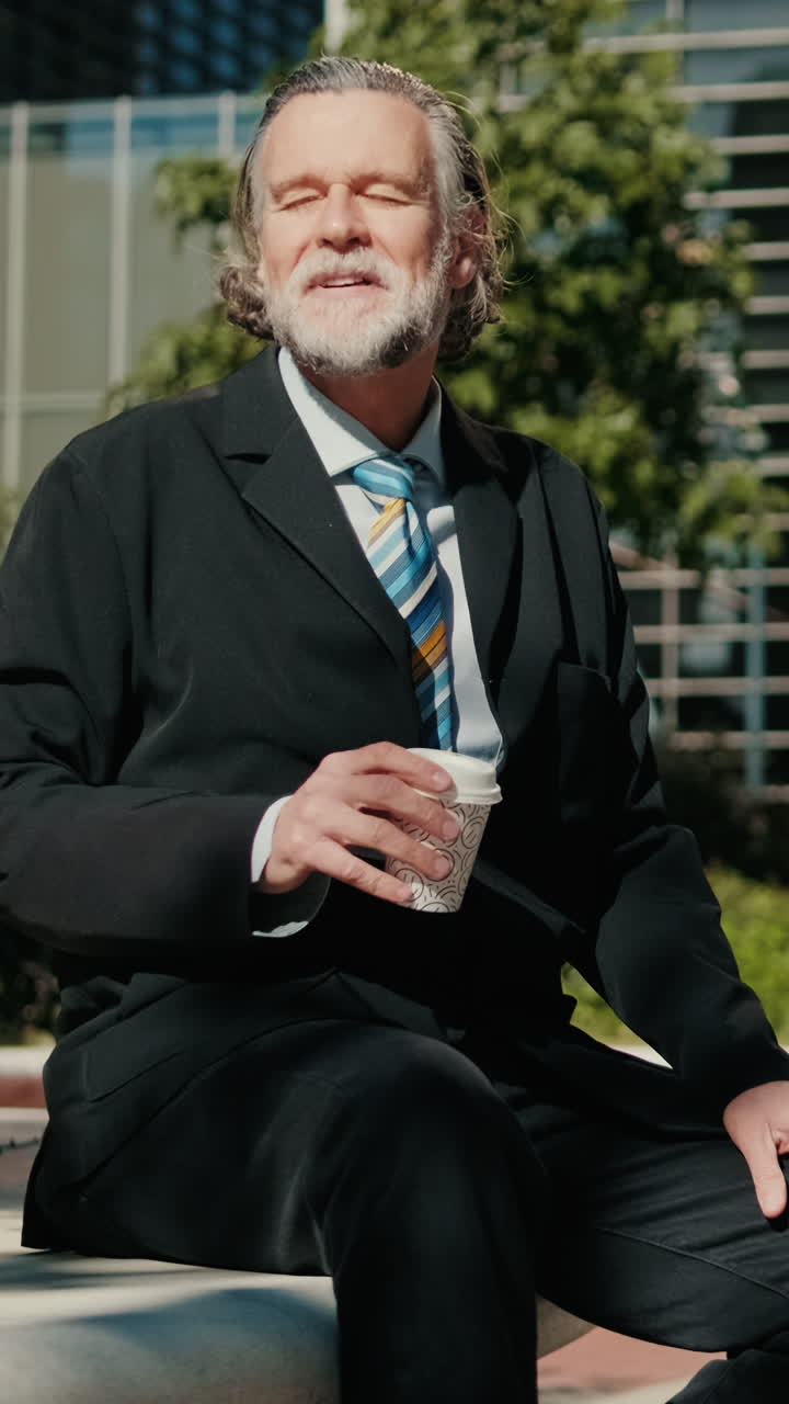 Senior Businessman Enjoys Coffee Outside Office