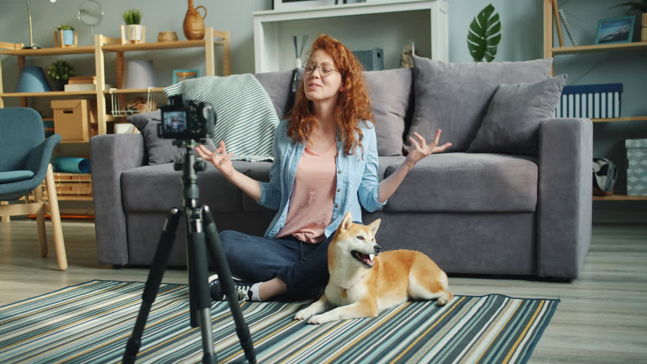 Woman vlogging with her dog in the living room