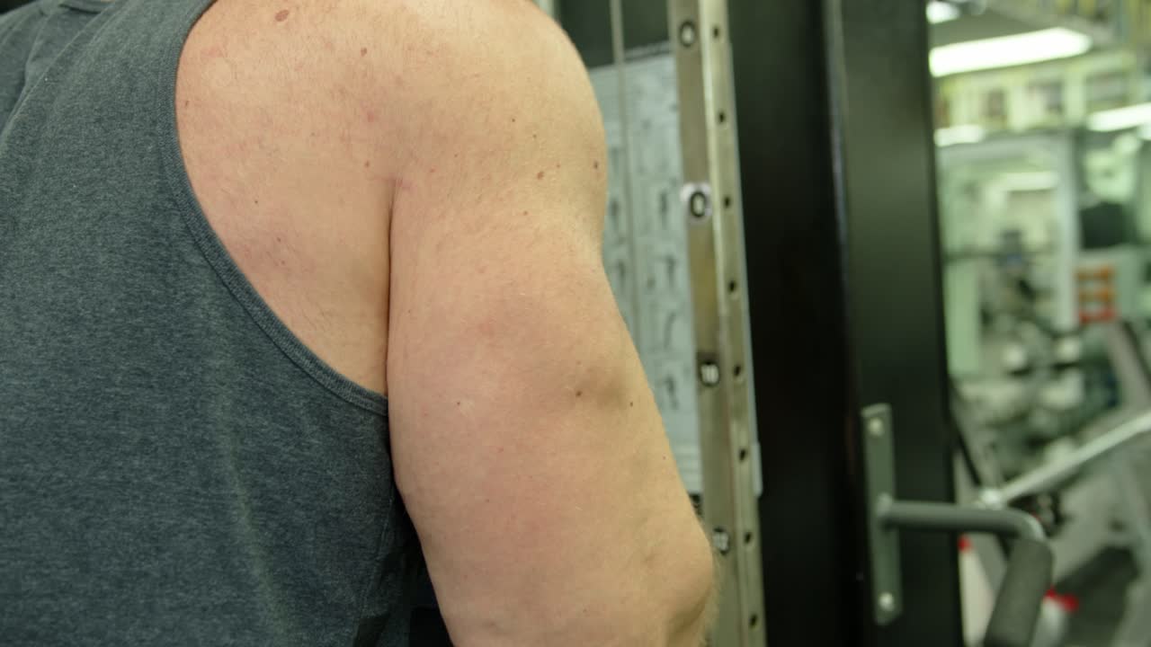 Strong bodybuilder lifting weights. Athletic person effort