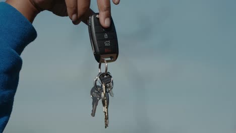 a set of keys being held up by a car key fob