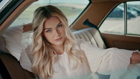 woman passenger sitting car back seat close up. girl relaxing in retro auto.