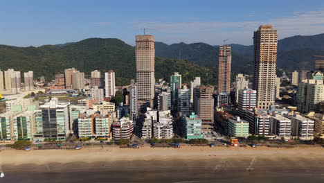 skyscrapers line the beach at itapema – meia praia, paraná, brazil, blending city and coast