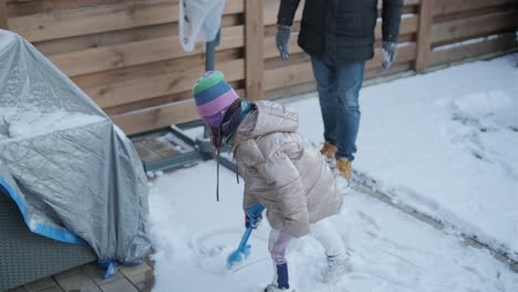 grandfather and granddaughter having fun in the snow