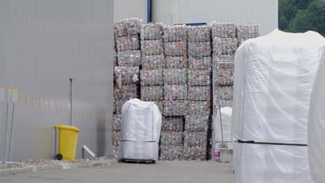 waste plastic bottles ballots outside recycling facility plant company