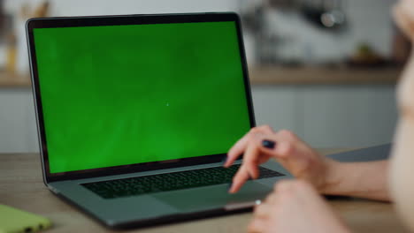 Woman-using-mockup-laptop-working-remotely-at-home-close-up.-Hands-scrolling