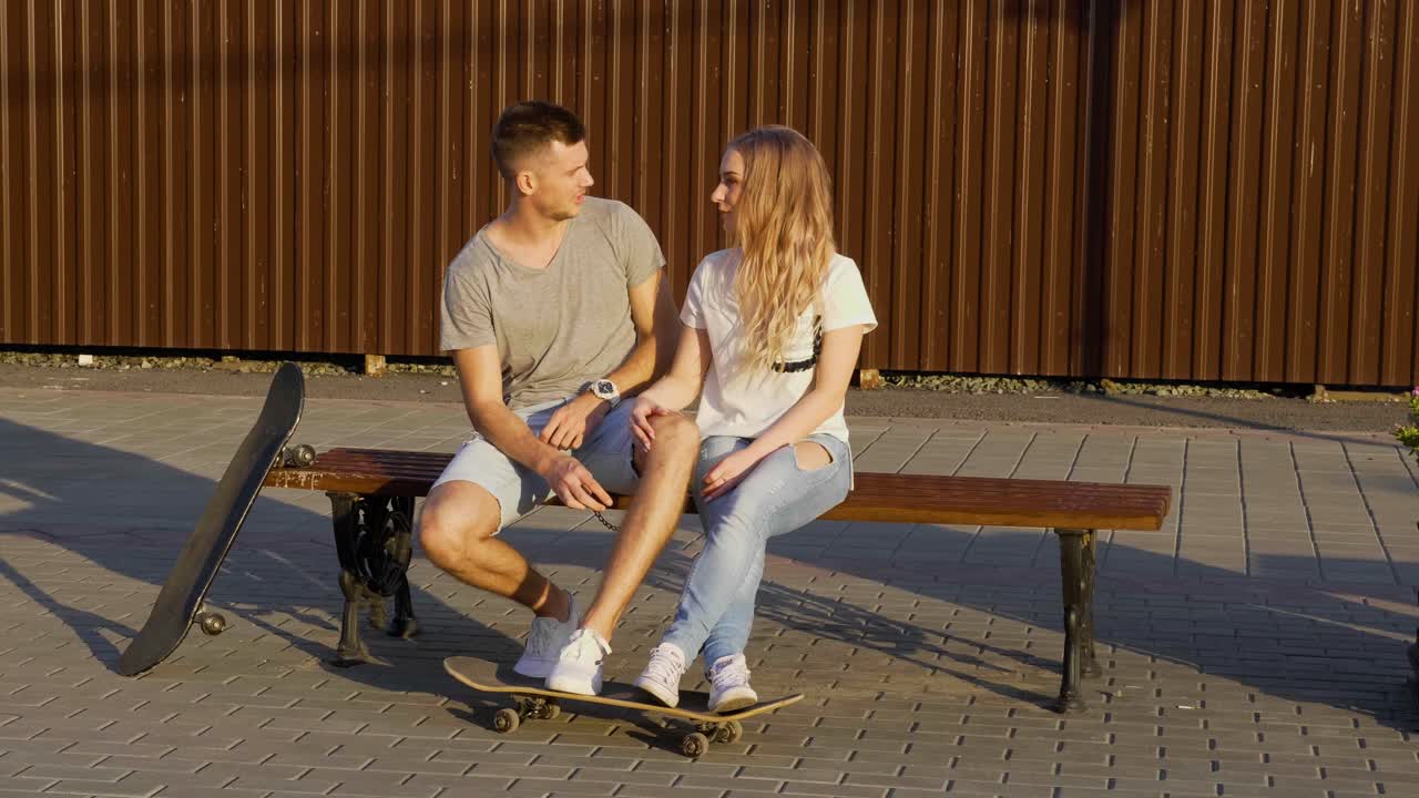 Couple Sitting on a Bench Outdoors