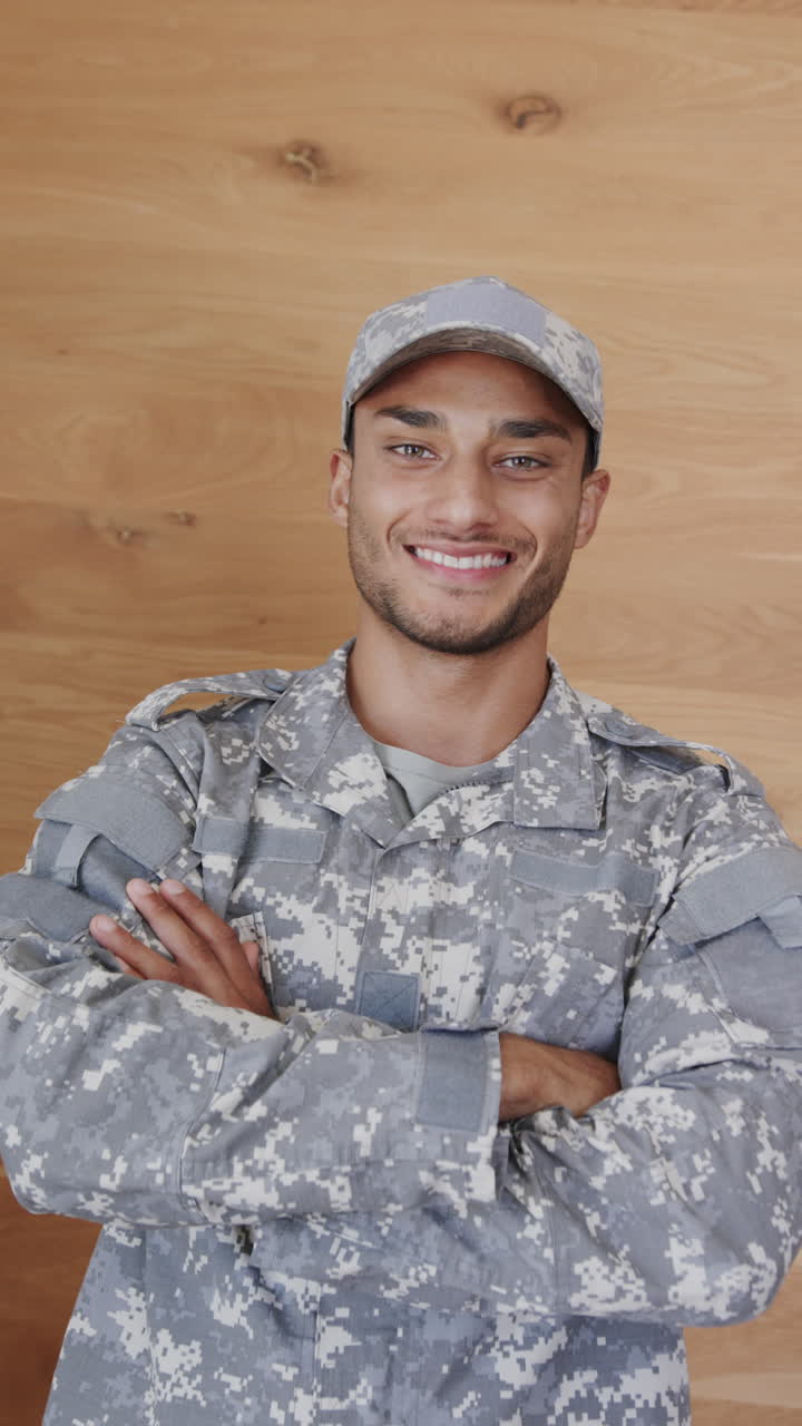 Vertical video portrait of happy latino male soldier in uniform, slow motion