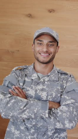 Vertical video portrait of happy latino male soldier in uniform, slow motion
