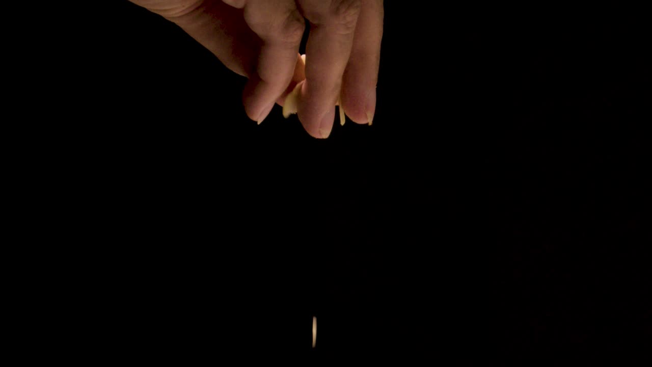 espolvorear almendras en copos en cámara súper lenta sobre un fondo negro