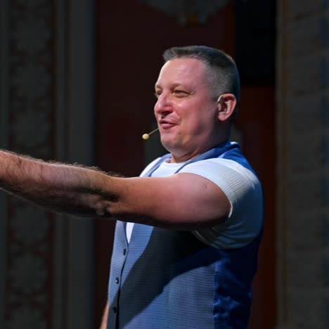 actor on classic theater stage. man is speaking in spotlights during the performance. side view video