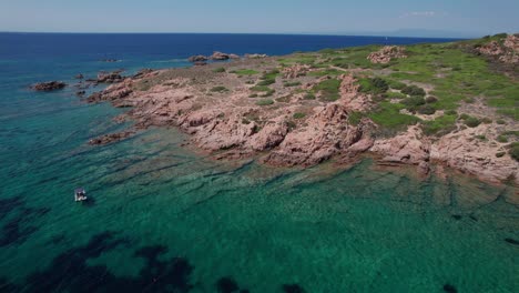 aerial circle pan footage on rocky seashore of sardinia island in italy during summertime