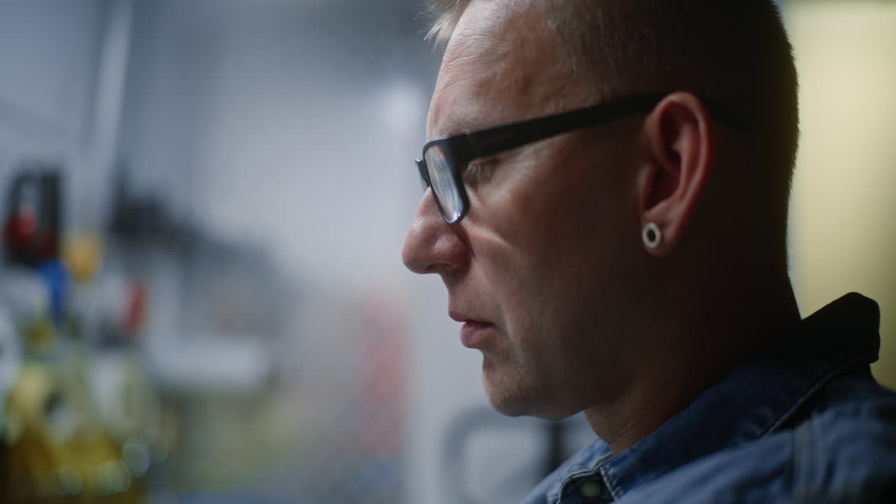 During Working Day in Workshop: Close Up of Focused Male Technician, Maintenance Worker Performing Detailed Manual Maintenance, Doing Handwork. Manual Labor, Craftsmanship, Repair Work. Vertical Shot.