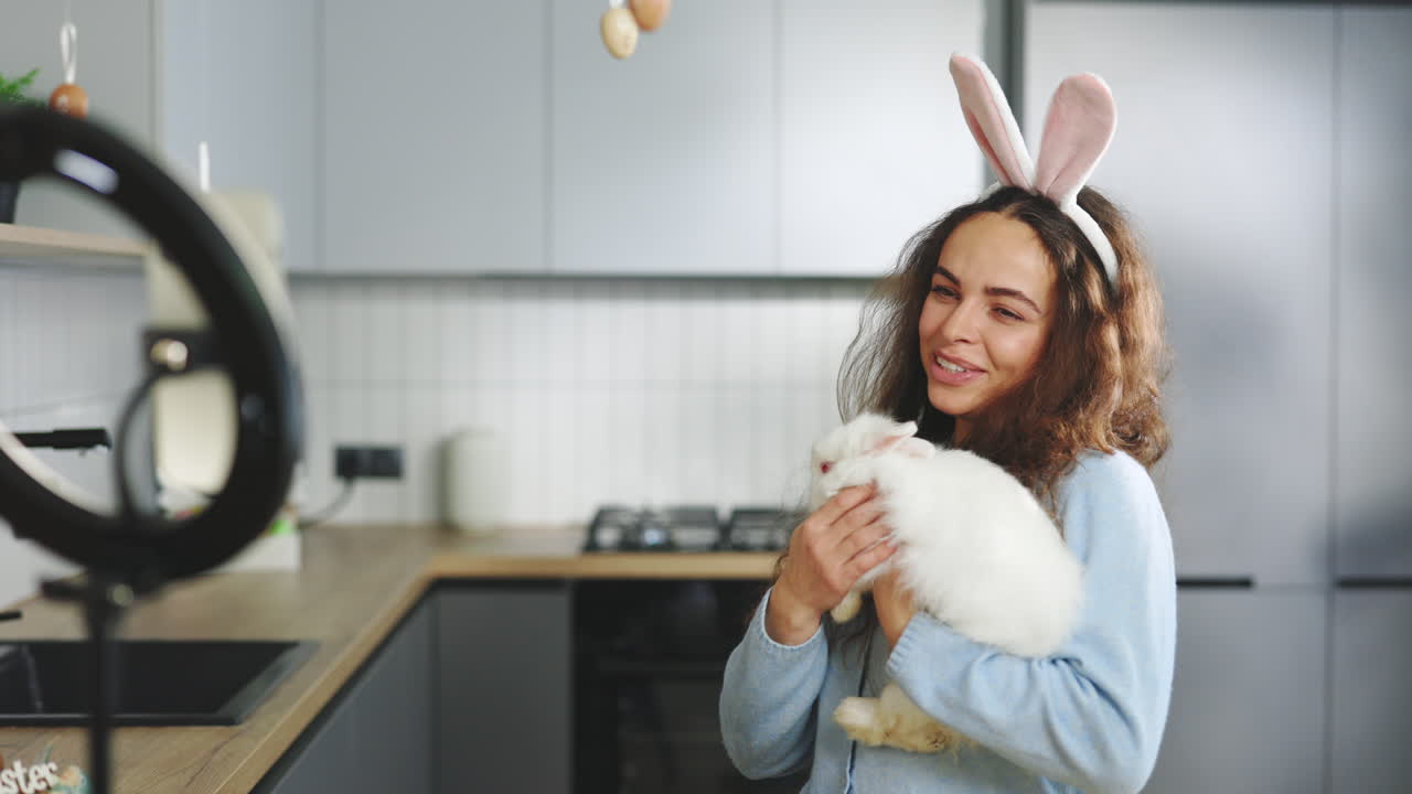 Woman interacting with a rabbit, Easter-themed video content