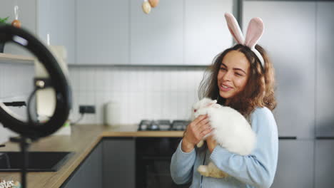 woman interacting with a rabbit, easter-themed video content