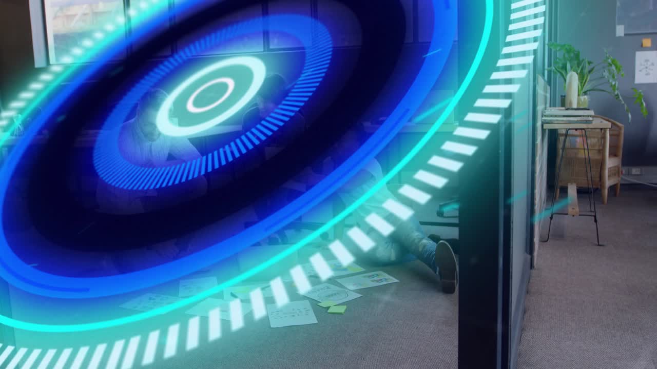 Tech team planning on floor standing man gesturing, activating AR disc expanding covering laptop