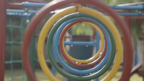 backward shot of colorful circular pipes as obstacles in kindergarten playground