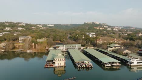 Aerial-view-of-Lake-Austin-Marina,-boat-slips-and-homes-in-Westlake,-Austin,-Texas-aerial-orbit-at-sunrise-in-4k