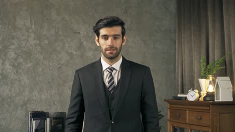 portrait of happy smiling business middle east man crossing arms, chief executive officer or ceo person with suit standing in room.