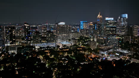 atlanta georgia aerial v901 hyperlapse drone flyover and around vibrant midtown neighborhood capturing illuminated urban cityscape and street traffics at night - shot with mavic 3 pro cine - july 2023