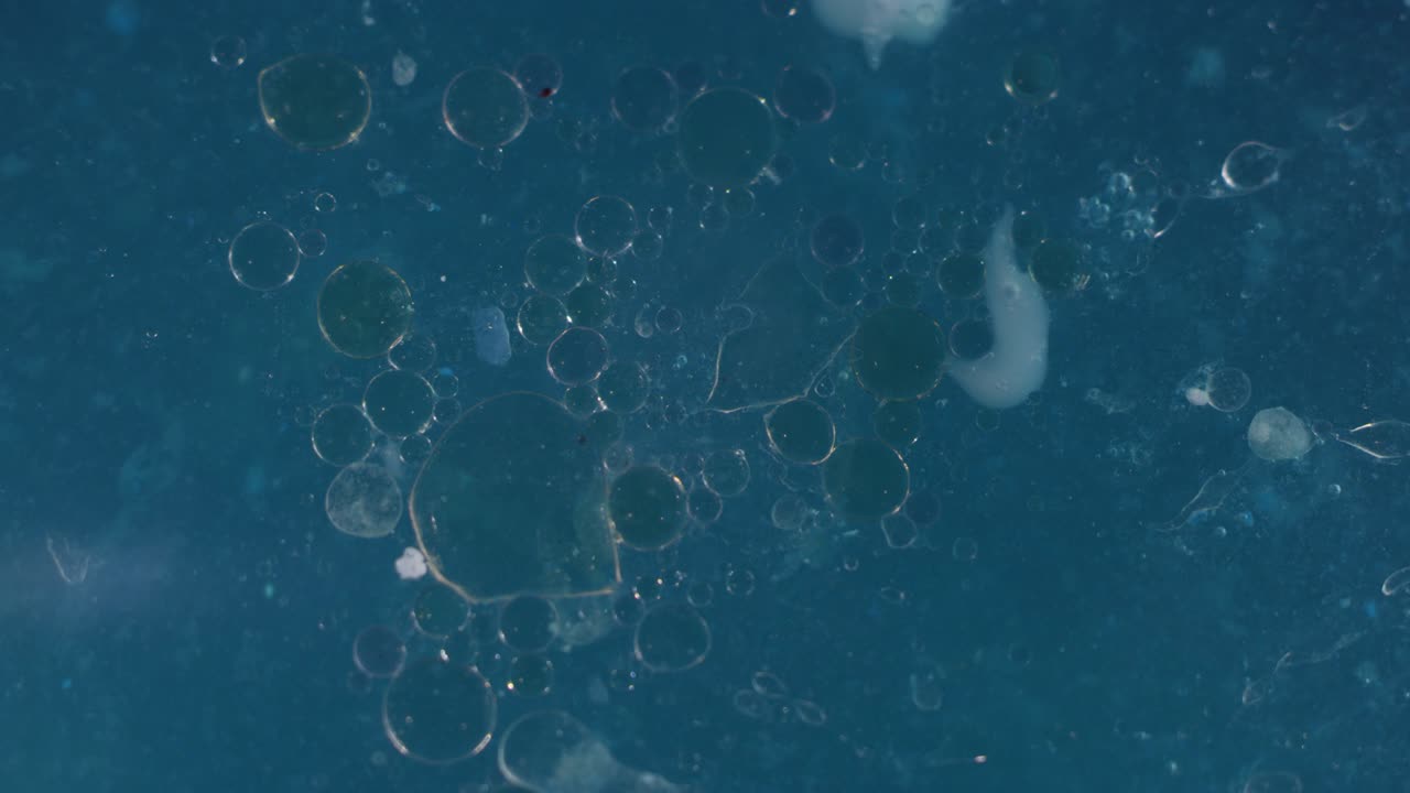 Spirling dark blue liquid bubbling textures. Macro abstract background