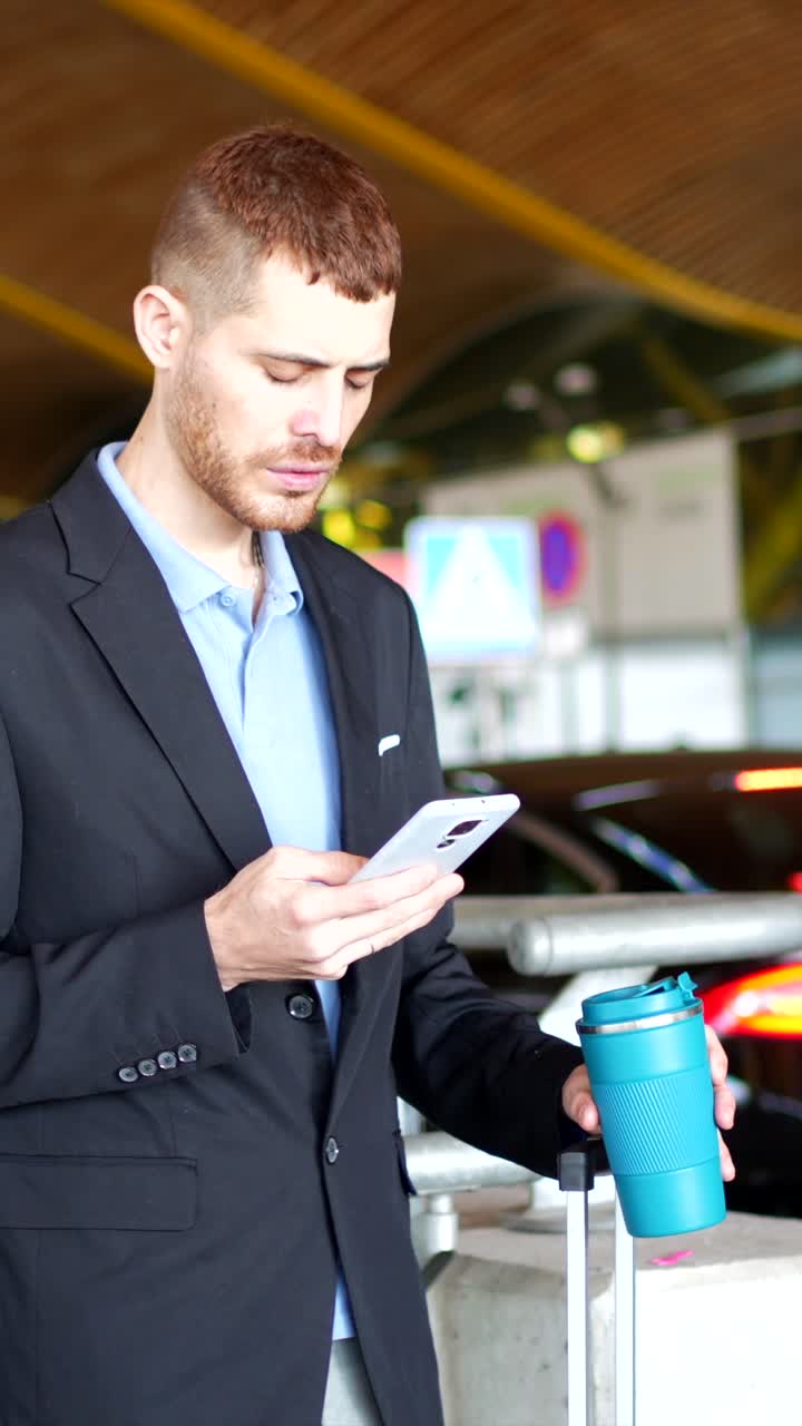 Man in Suit Talking on Phone at Airport