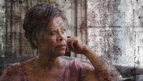 animation of black shapes over senior african american woman at home