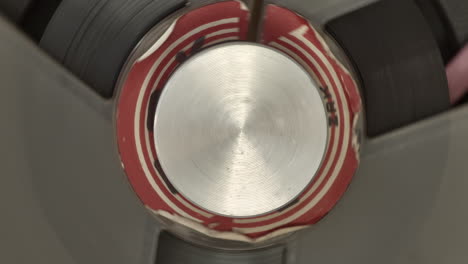 Magnetic-deck-in-tape-recorder,-extreme-top-down-closeup-of-spinning-center