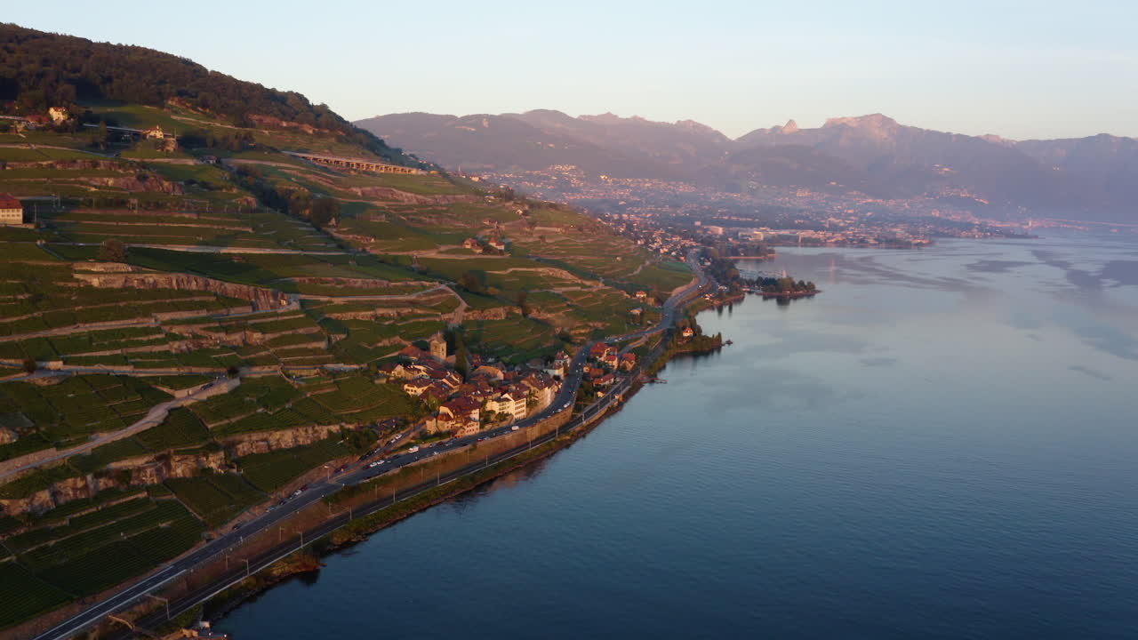 Majestic View Of Saint-Saphorin Village And The Terraces Of Wine Vineyards In Lavaux By The Shore Of Lake Geneva - aerial shot