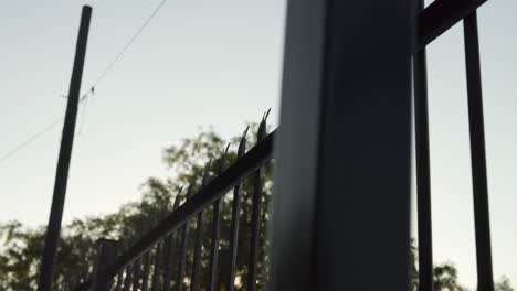 Pan-shot-of-security-palisade-fence-with-spikes-on-wall