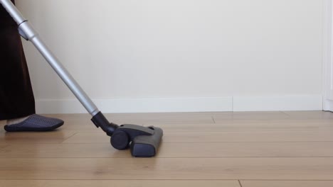 a vacuum cleaner cleaning a wood floor