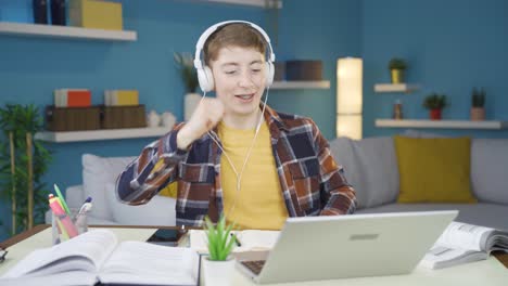 Student-listening-to-music-and-dancing-while-studying.