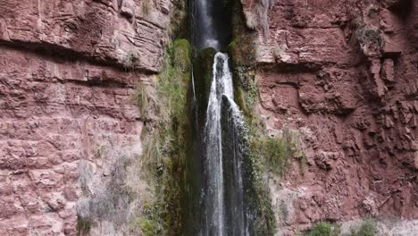 drone rising shot of flowing perolniyoc waterfall in peru during beautiful weather outdoors