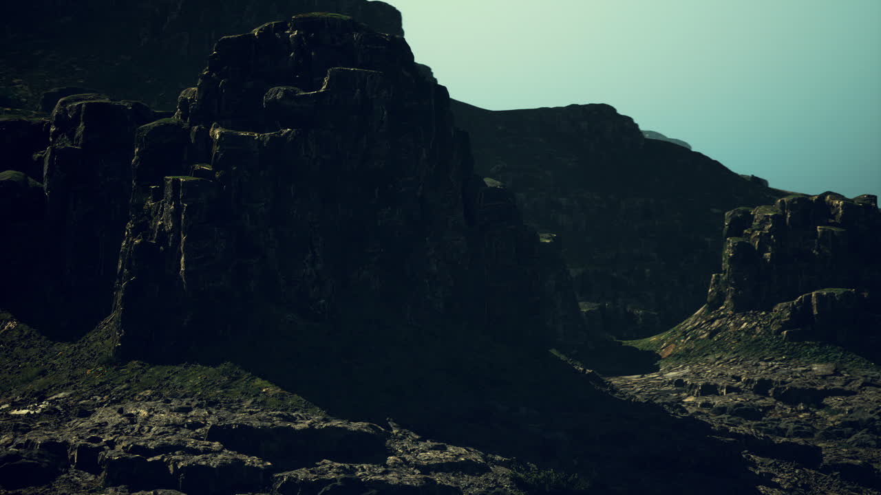 Majestic rocky formations under a dramatic sky at dusk