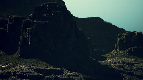 majestic rocky formations under a dramatic sky at dusk